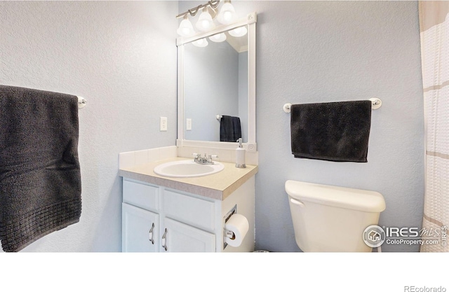 bathroom with vanity and toilet