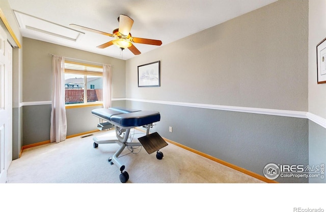 carpeted home office with ceiling fan