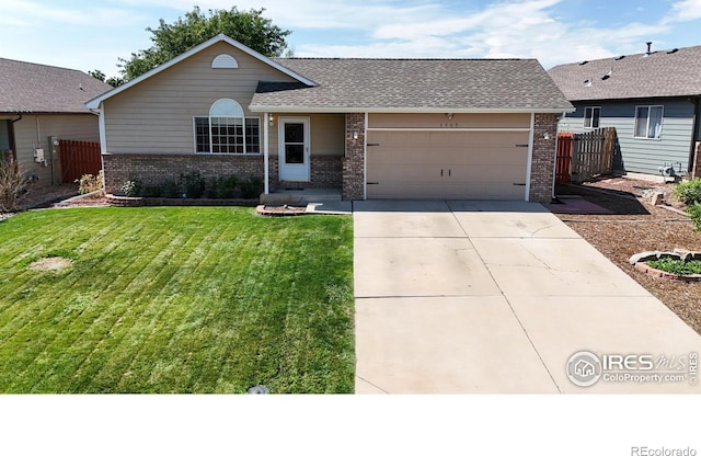 single story home featuring a garage and a front yard