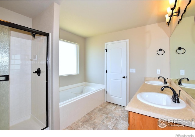 bathroom featuring vanity and separate shower and tub