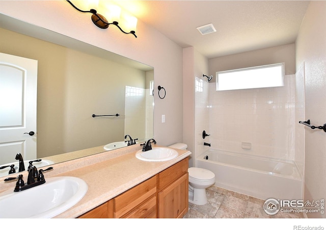 full bathroom featuring shower / bathtub combination, vanity, and toilet