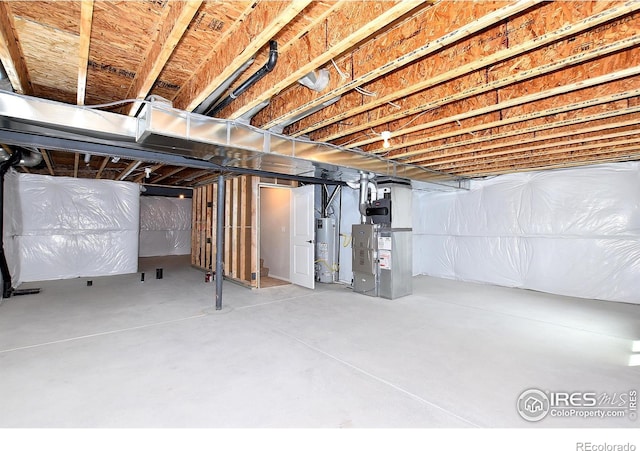 basement with gas water heater and heating unit