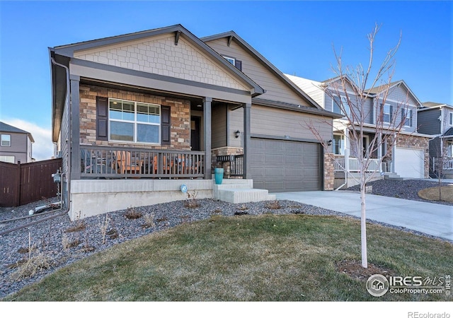 craftsman inspired home featuring a garage, covered porch, and a front lawn