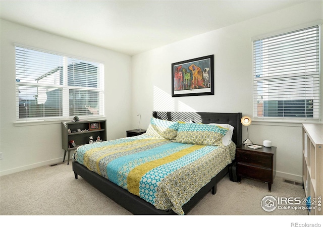 bedroom with visible vents, carpet flooring, and baseboards