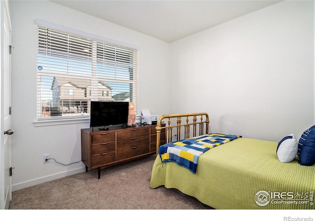 bedroom with baseboards and carpet