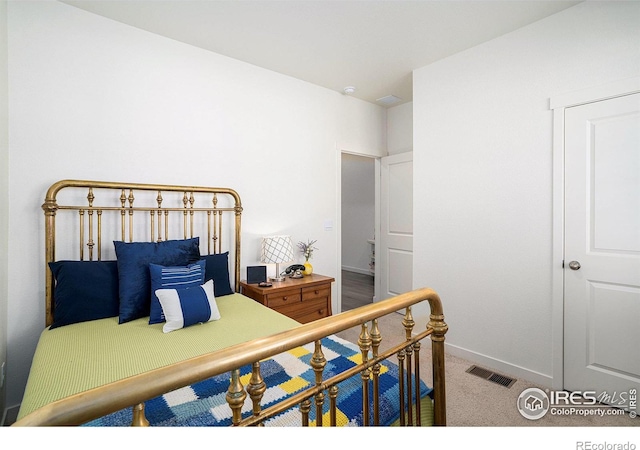 carpeted bedroom with visible vents and baseboards