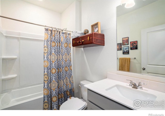 full bath with toilet, vanity, and shower / bath combo with shower curtain