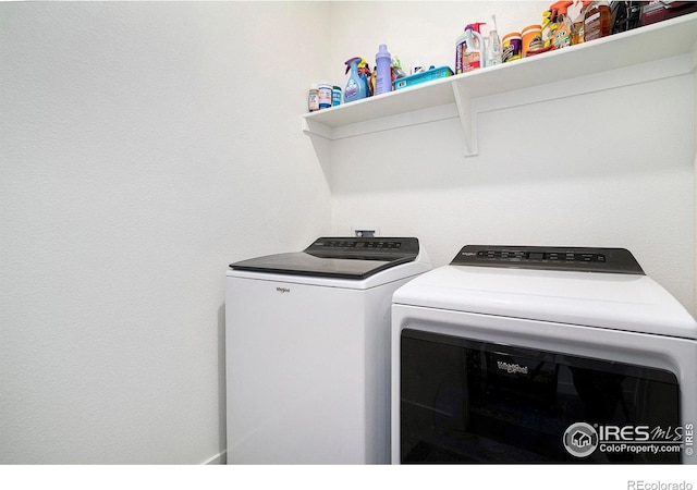 clothes washing area with laundry area and separate washer and dryer