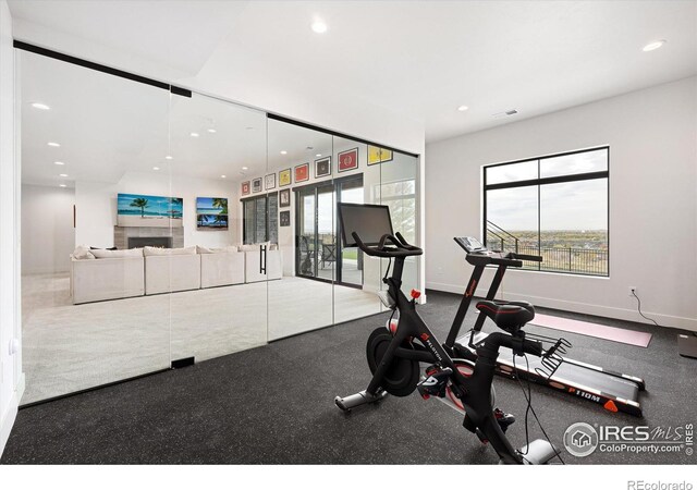 workout room with visible vents, recessed lighting, a fireplace, and baseboards