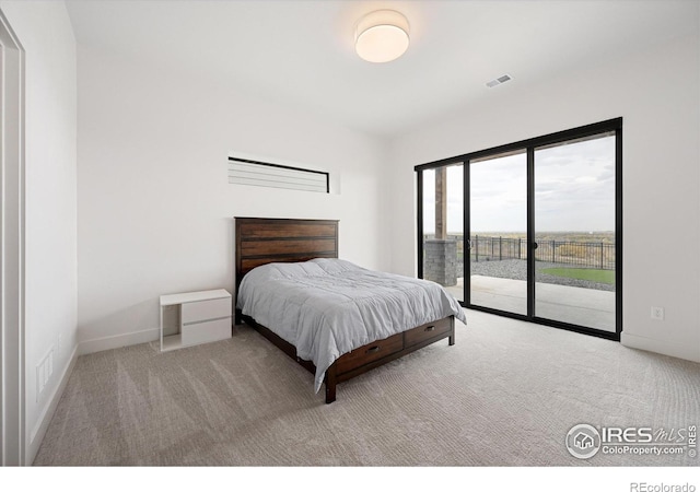 bedroom featuring carpet floors, baseboards, visible vents, and access to outside