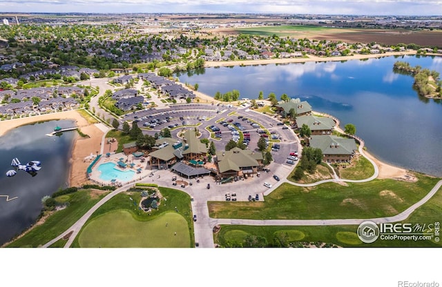 drone / aerial view featuring a residential view and a water view