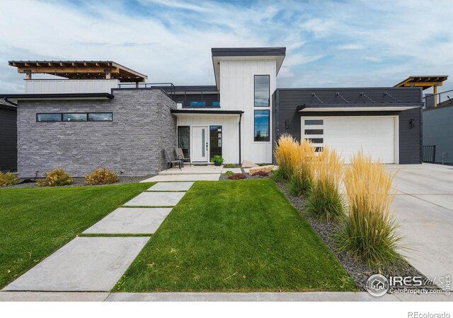 modern home featuring a front lawn, an attached garage, board and batten siding, and driveway