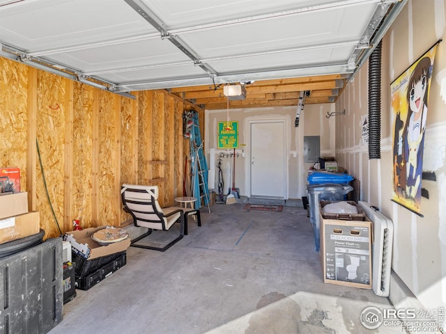 garage with a garage door opener and electric panel