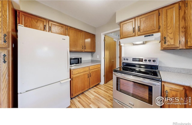 kitchen with light wood-type flooring and appliances with stainless steel finishes