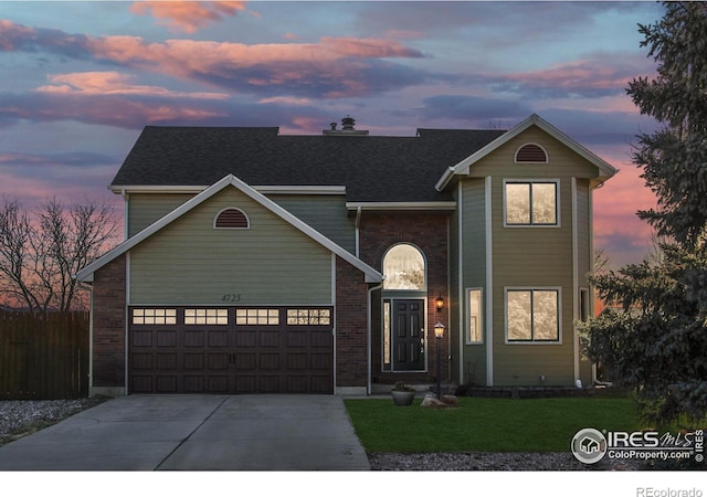 view of front property featuring a yard and a garage