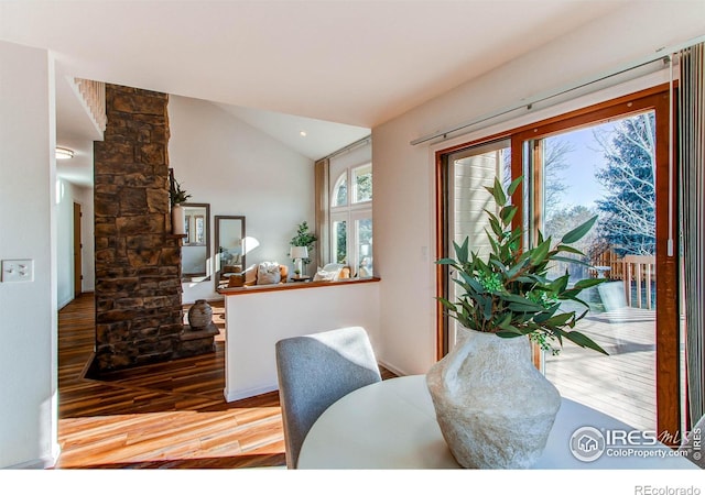 dining room with lofted ceiling, light hardwood / wood-style flooring, and decorative columns