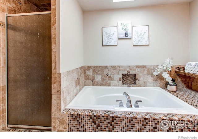 bathroom with shower with separate bathtub