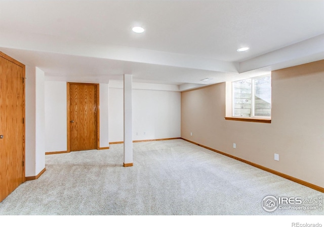 basement featuring light colored carpet