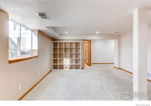 basement with carpet and a textured ceiling