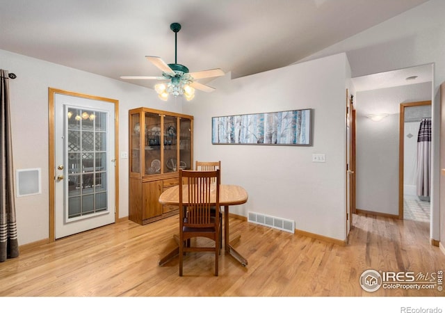 dining space with ceiling fan and light wood-type flooring