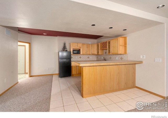 kitchen featuring black appliances, light tile patterned flooring, light brown cabinetry, decorative backsplash, and kitchen peninsula