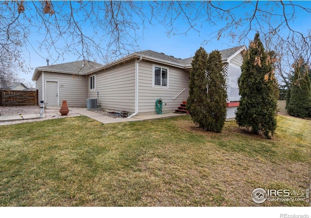 rear view of house with a patio, a lawn, and central air condition unit