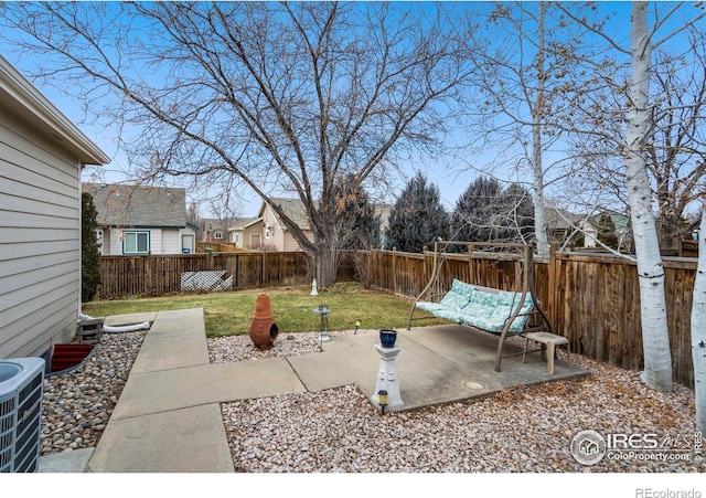 view of yard with a patio and central air condition unit