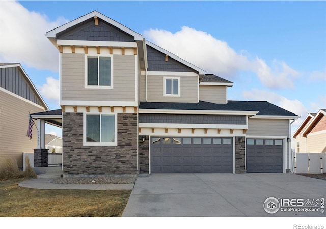 view of front of home with concrete driveway and stone siding