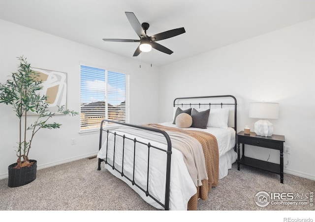 carpeted bedroom featuring a ceiling fan and baseboards