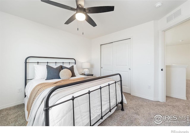 carpeted bedroom featuring baseboards, visible vents, ceiling fan, and a closet