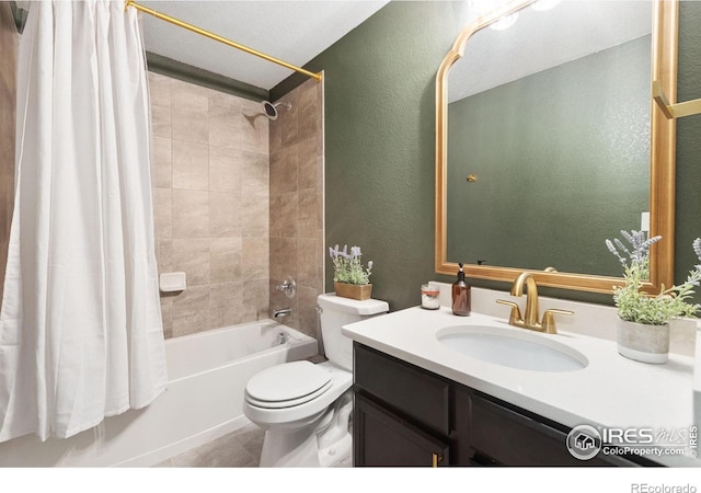 bathroom with shower / tub combo with curtain, a textured wall, toilet, vanity, and tile patterned flooring