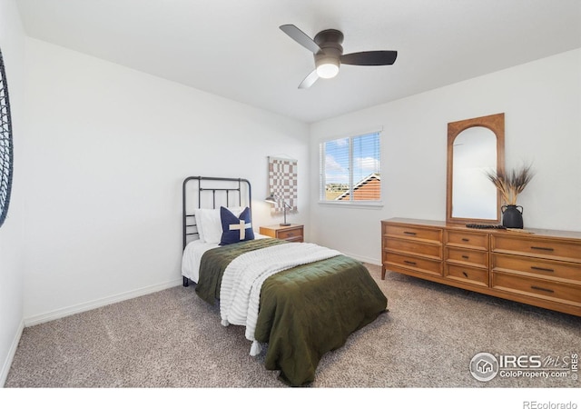 carpeted bedroom with baseboards and a ceiling fan