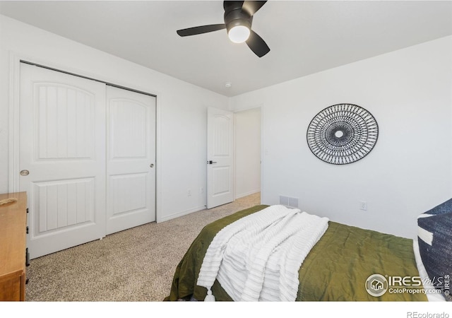 bedroom with a ceiling fan, a closet, visible vents, and carpet flooring