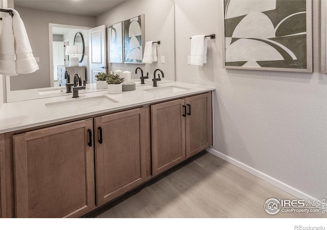 bathroom with vanity and hardwood / wood-style flooring