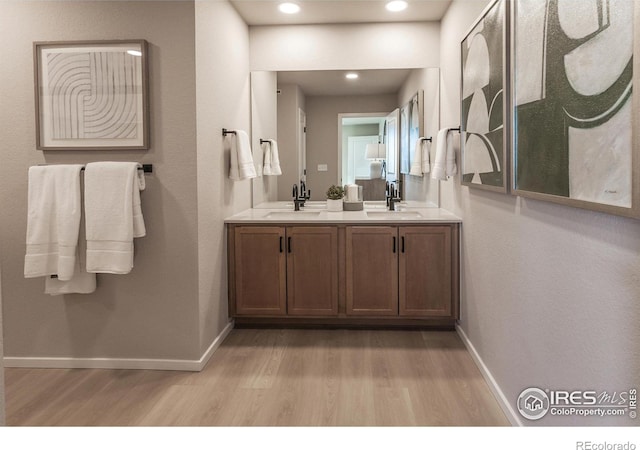 bathroom featuring wood-type flooring and vanity