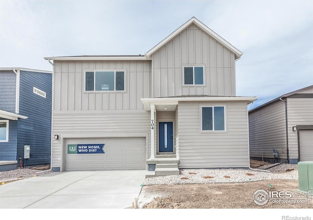 view of front facade featuring an attached garage, board and batten siding, and driveway