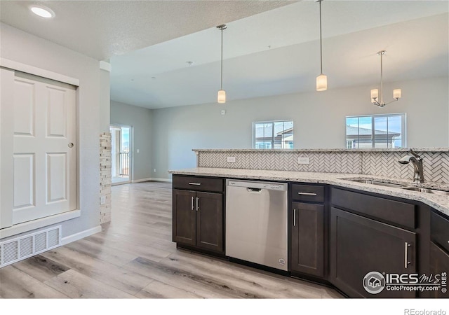 kitchen with sink, dishwasher, hanging light fixtures, dark brown cabinets, and light stone counters