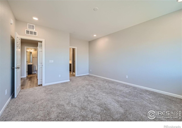 unfurnished bedroom featuring light carpet