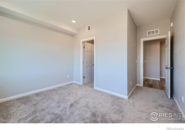 unfurnished bedroom with light colored carpet