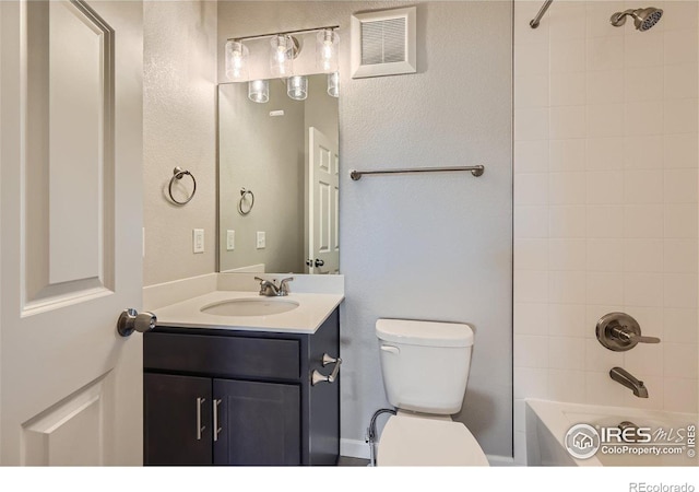 full bathroom with vanity, toilet, and tiled shower / bath