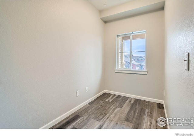 empty room featuring dark hardwood / wood-style flooring