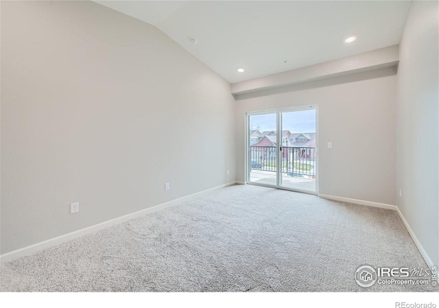 empty room with lofted ceiling and carpet floors