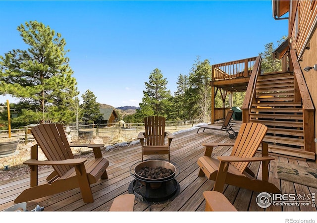 deck with a mountain view and a fire pit