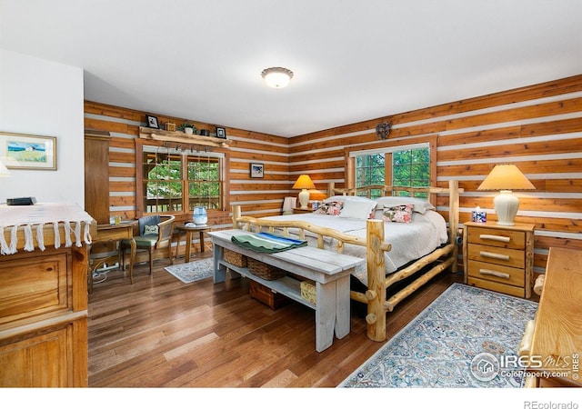 bedroom with wood-type flooring and rustic walls