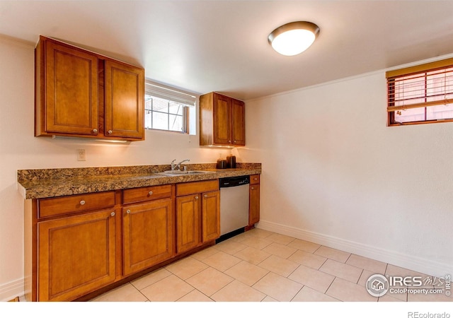 kitchen with sink, light tile patterned floors, and stainless steel dishwasher