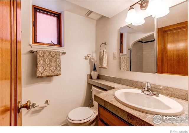 bathroom with vanity, toilet, and walk in shower