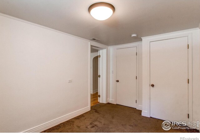 unfurnished bedroom featuring dark colored carpet