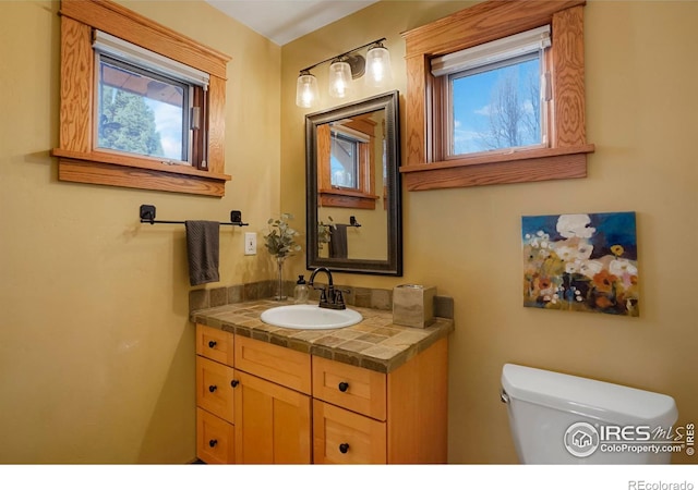 bathroom featuring vanity and toilet