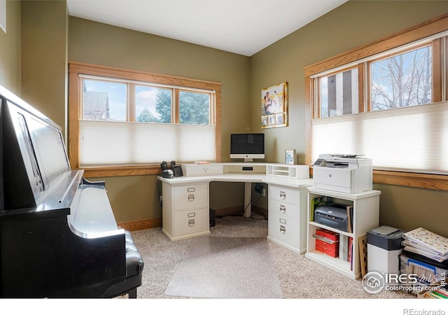 home office with baseboards and light colored carpet