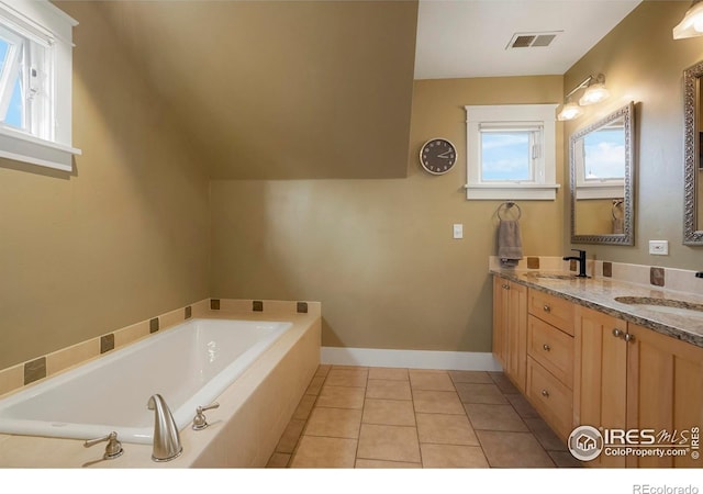 full bathroom with visible vents, a sink, a garden tub, and tile patterned floors